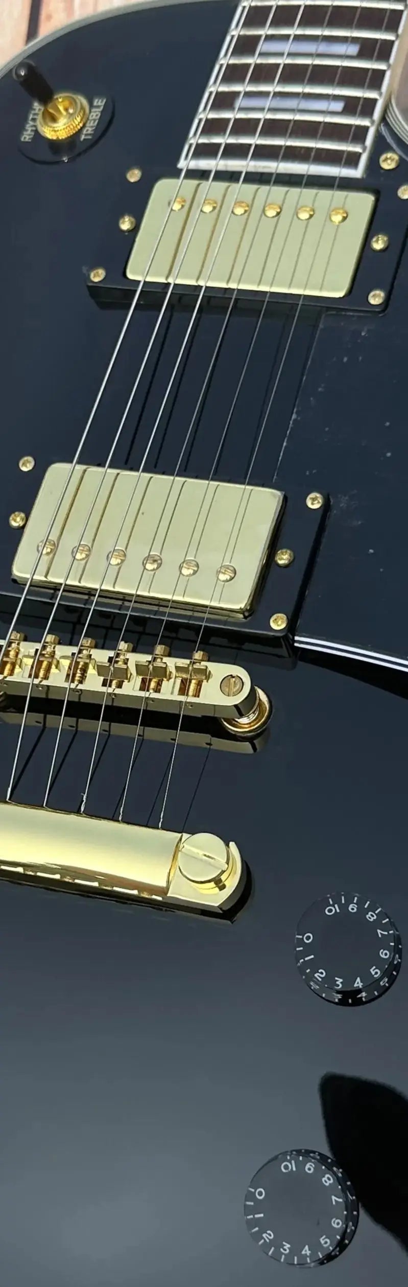 Customized electric guitar, black shiny, gold accessories, imported